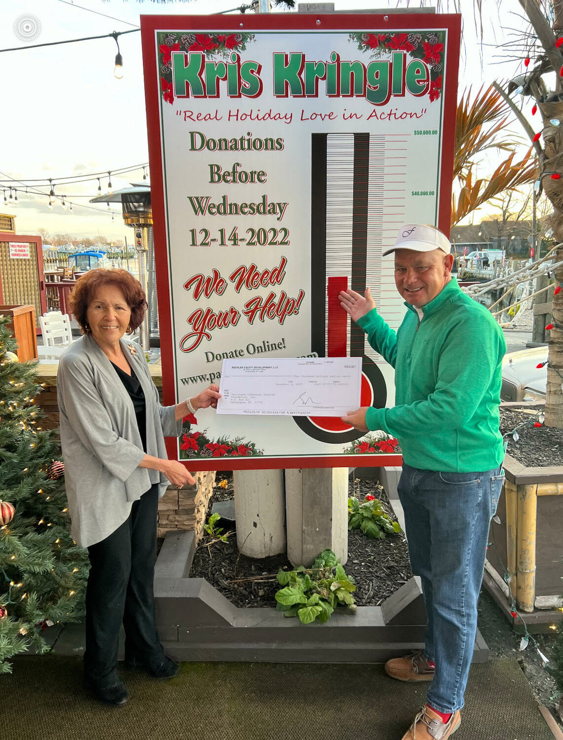 Rechler Equity Development LLC presents Mark Miller with a donation to the Kris Kringle Fund (2022).